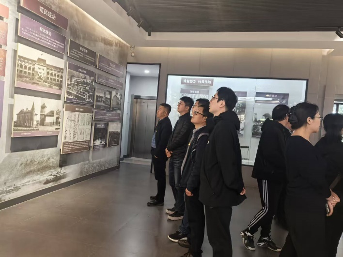 A group of people looking at a wall  AI-generated content may be incorrect.